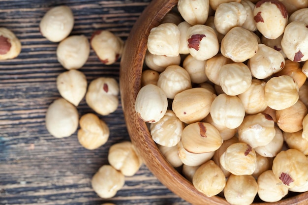 Peeled and roasted hazelnuts on a wooden table