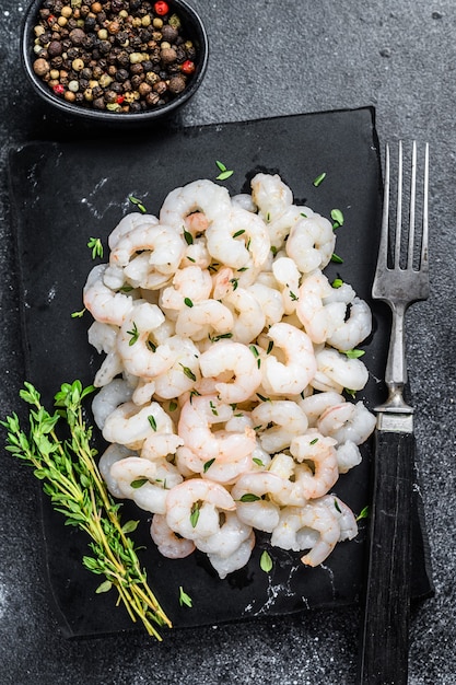 Peeled Shrimps, Prawns on a marble board. Black background. top view.