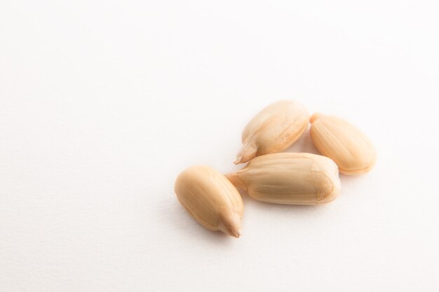 Peeled sunflower seeds on a white background