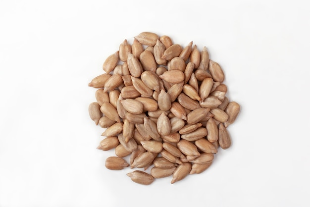 Peeled sunflower seeds on white