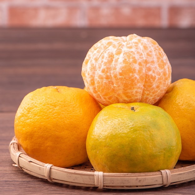 Peeled tangerines in a bamboo sieve basket