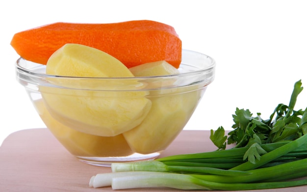 Peeled vegetables in bowl isolated on white