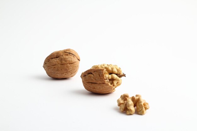 Peeled walnut closeup Golden walnut kernel on a white background Healthy foods Selective Focus