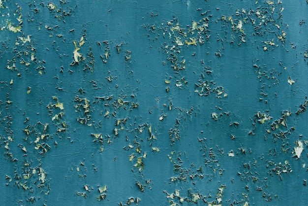 Peeling blue paint on old wall background texture. Abstract blue paint background.