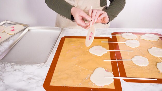 Peeling large homemade lollipops from silicone mat.