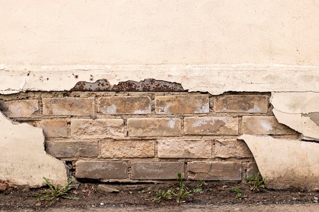 Peeling paint on an old brick wall