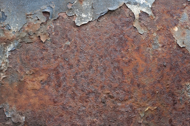 Peeling paint on old rusty metal.