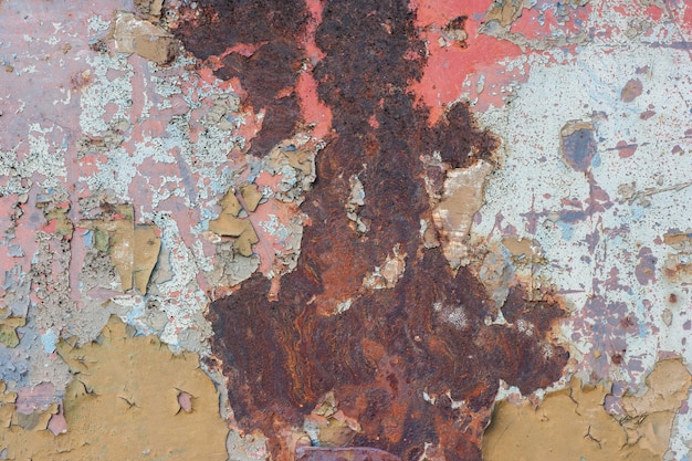 Peeling paint on old rusty metal.