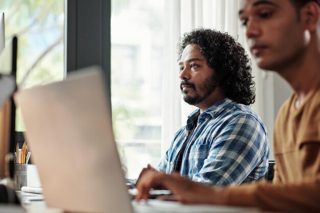 Peinzende Indiase programmeur aan het werk