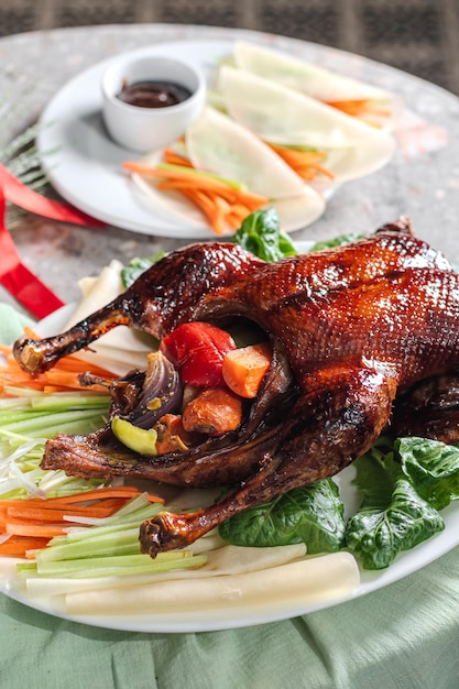 Premium Photo | Peking duck marinated in ginger with vegetables