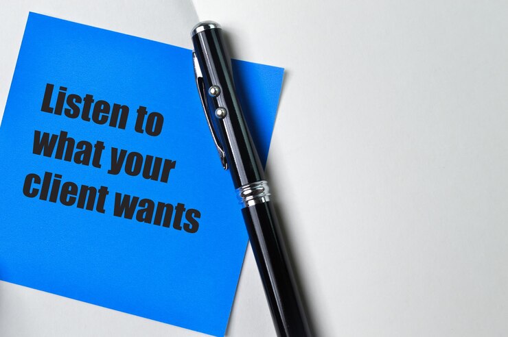 Photo pen and blue note phrase listen to what your client wants