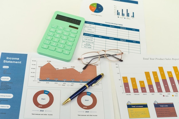 Pen and calculator on financial paper chart on desk