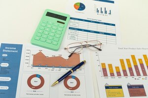 Pen and calculator on financial paper chart on desk