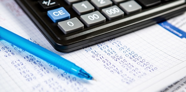 Pen and calculator. wall Items for doing business in the office in the composition.