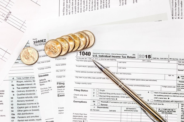 Premium Photo  Pen and coins on the tax form