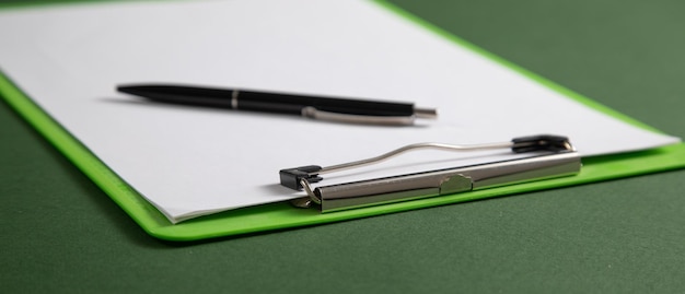 Pen and contract on the green background