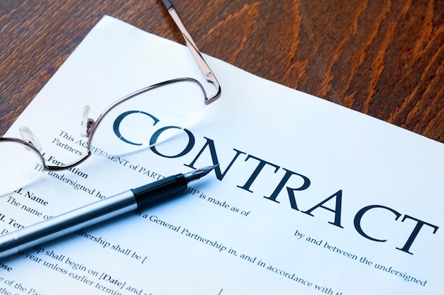 Pen and contract papers on wooden desk