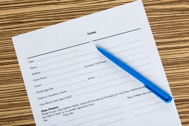 Pen and contract papers on wooden desk