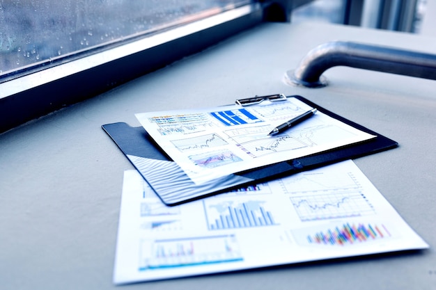 Photo pen and financial documents on the desktop in the office