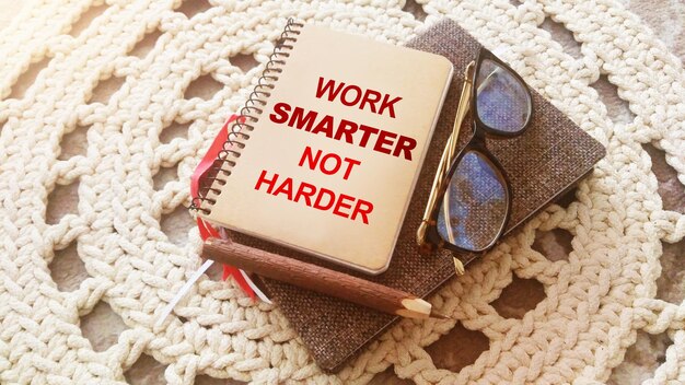 Pen glasses copybook Work Smarter Not Harder words Career business concept