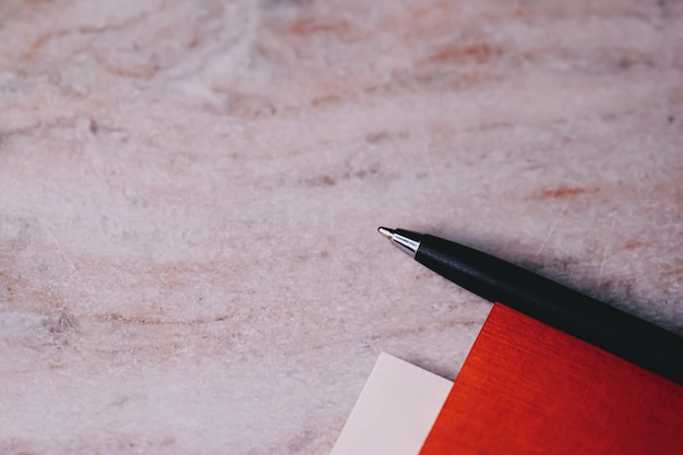 Pen and papers as office stationery closeup