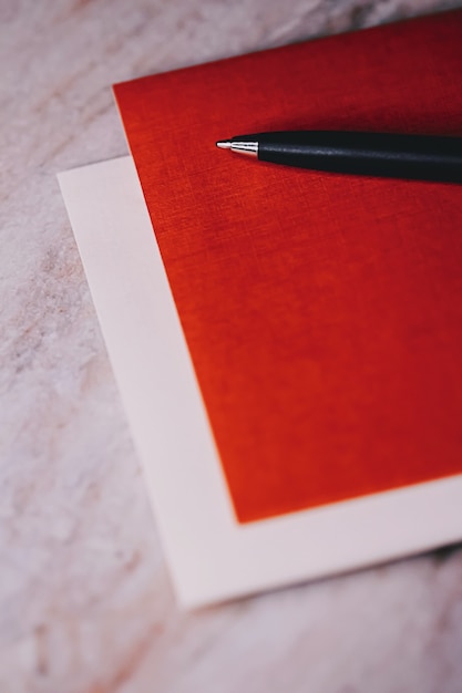 Pen and papers as office stationery closeup