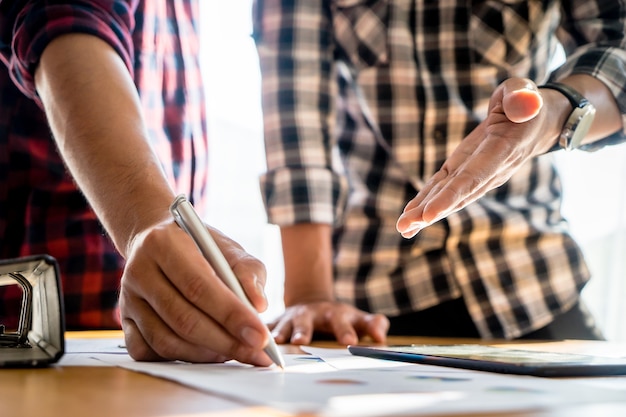 Pen and person hand discussing on business report