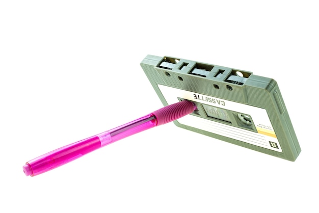 A pen pink and cassette tape compact  retro on white background