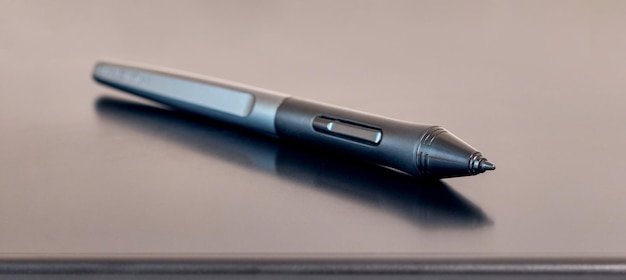 The pen stylus lies on the graphics tablet