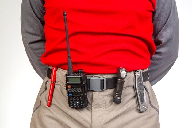Pen walkietalkie knife and flashlight with clips on the waistband of trekking pants edc items