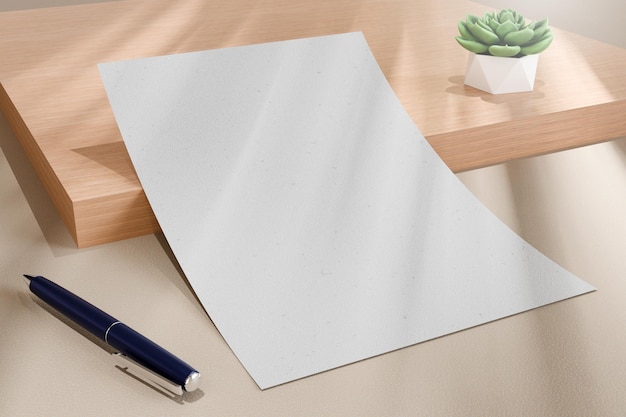 a pen and a white sheet of paper are on a table