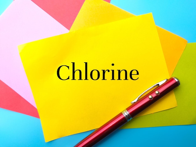 Pen with colorful paper with text Chlorine on a blue background