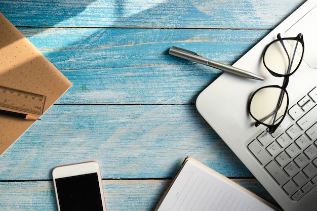 Pen with glasses and notebook at office