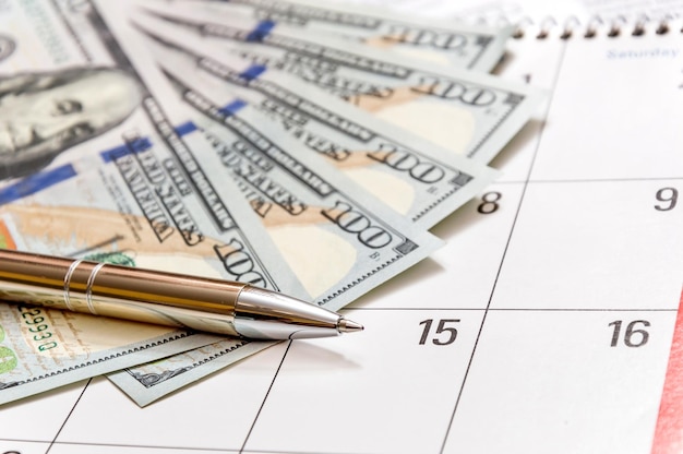 Pen with money on the calendar