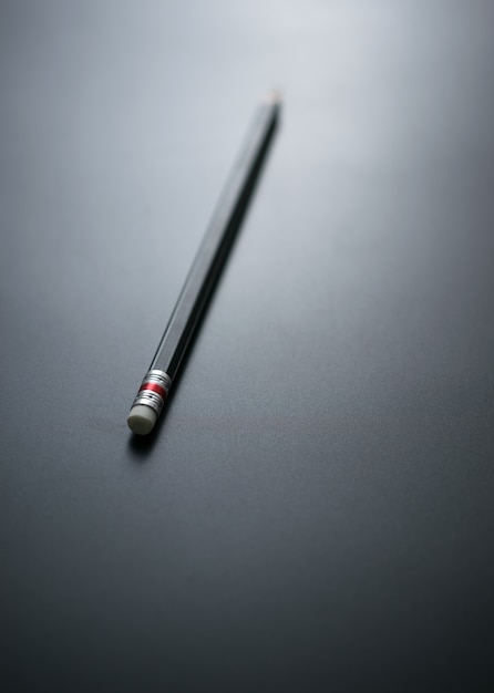 Pencil on blackboard focus at pencil eraser for mistake business concept background design.