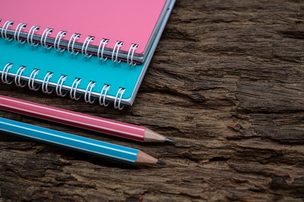 Pencil and book mockup on the old wood desk at the background