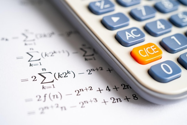 Pencil and calculator on mathematic formula exercise test paper in education school