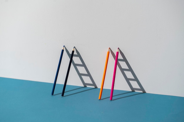 A pencil leaned on the wall and creating ladder made of shadow
