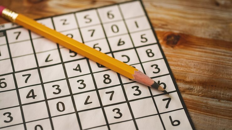 Photo pencil lying on a sudoku grid