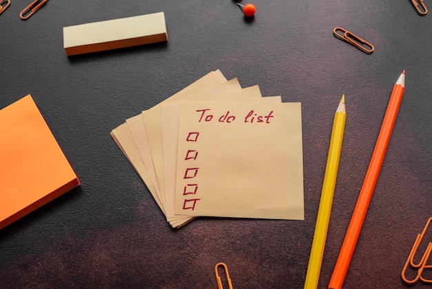 The pencil, paper clips and sheets for marks lie on a desktop