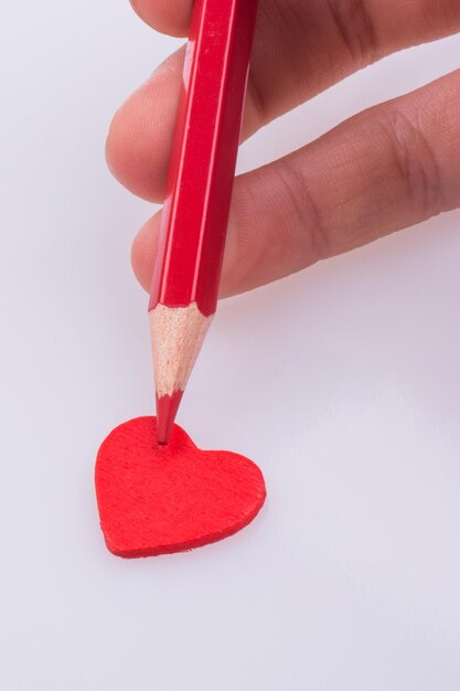 Pencil pointing a heart