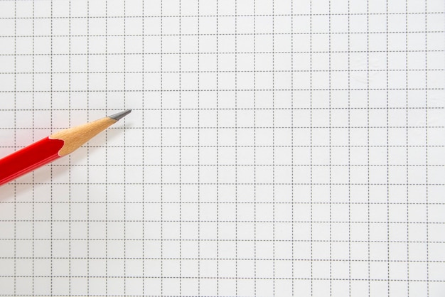 Pencil of red on the grid background