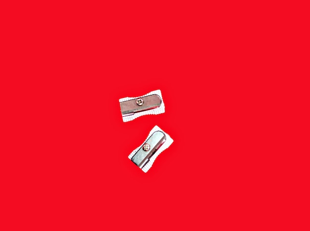 Pencil sharpener isolated on red background. Office supplies, back to school.