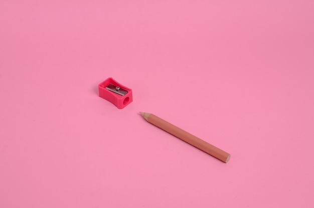 Pencil and sharpener on pink background