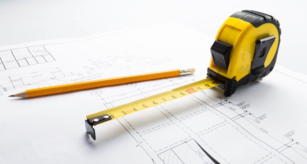 Pencil and Steel Tape Measure on Blueprint