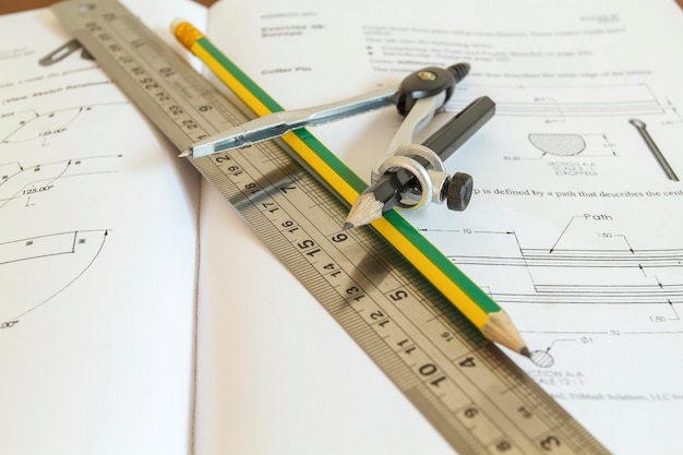 pencil with compasses and rulers on wood table