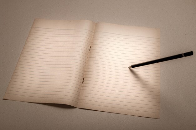 Pencil writing record lecture note pad into the empty white book