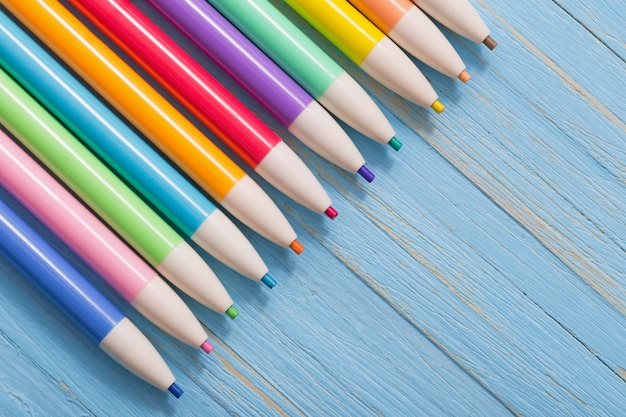 Pencils on  blue wooden background