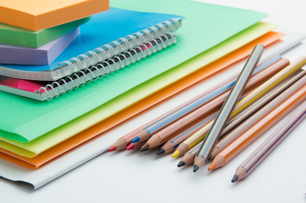 Pencils folders and notebooks on the office table