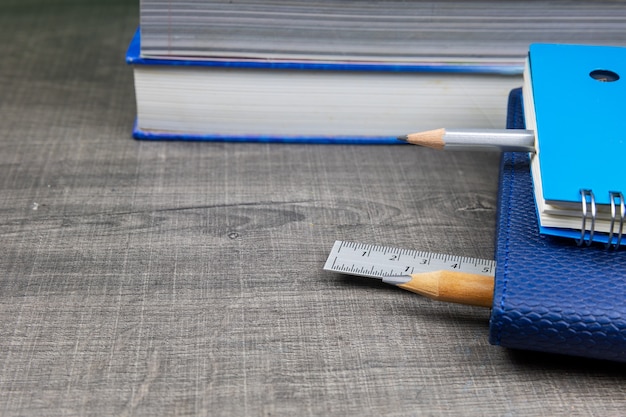 Pencils, notebooks, erasers, rulers, books on the table the concept back to school.